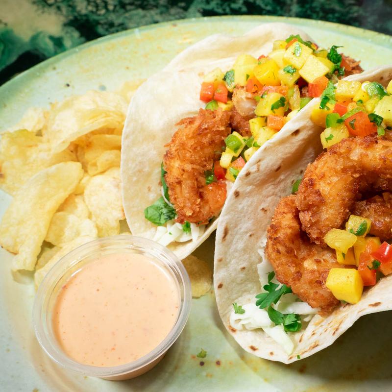Coconut shrimp tacos with mango salsa, sweet chili aioli, and chips.